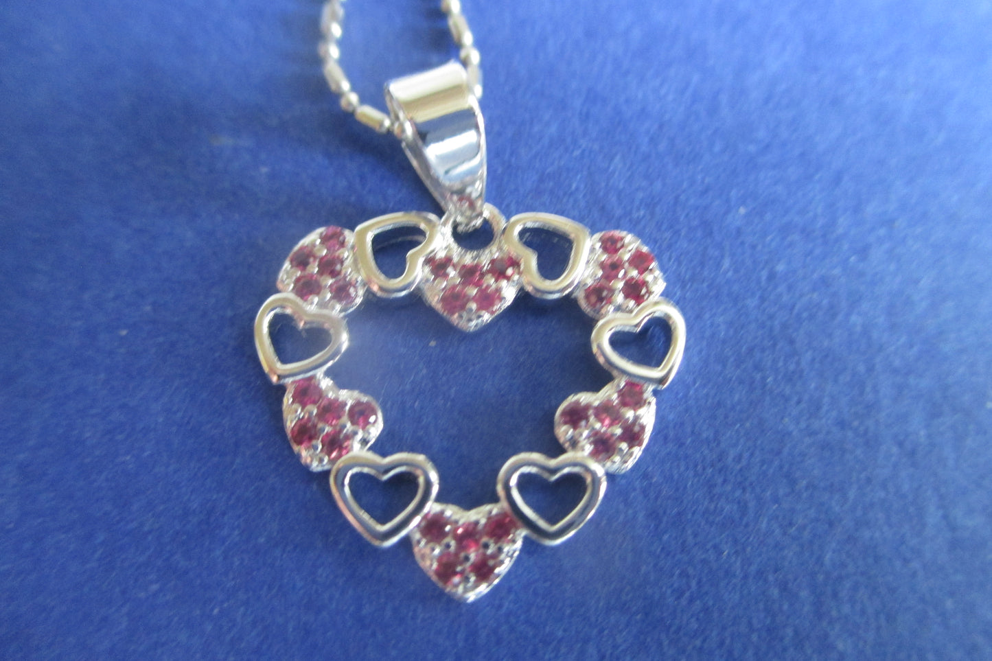 Silver hearts with red accent pendant