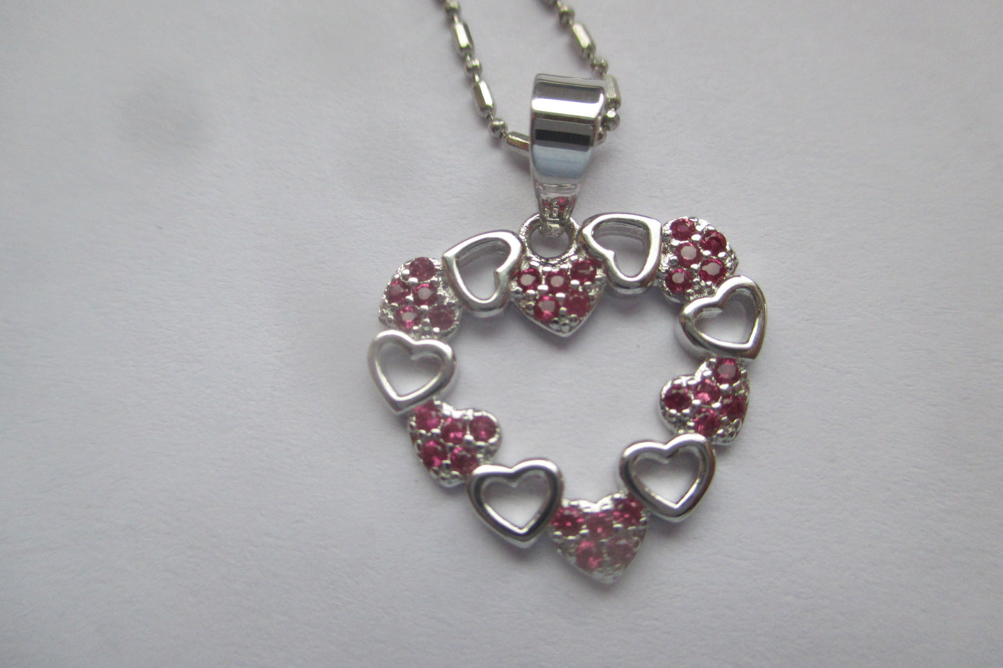 Silver hearts with red accent pendant
