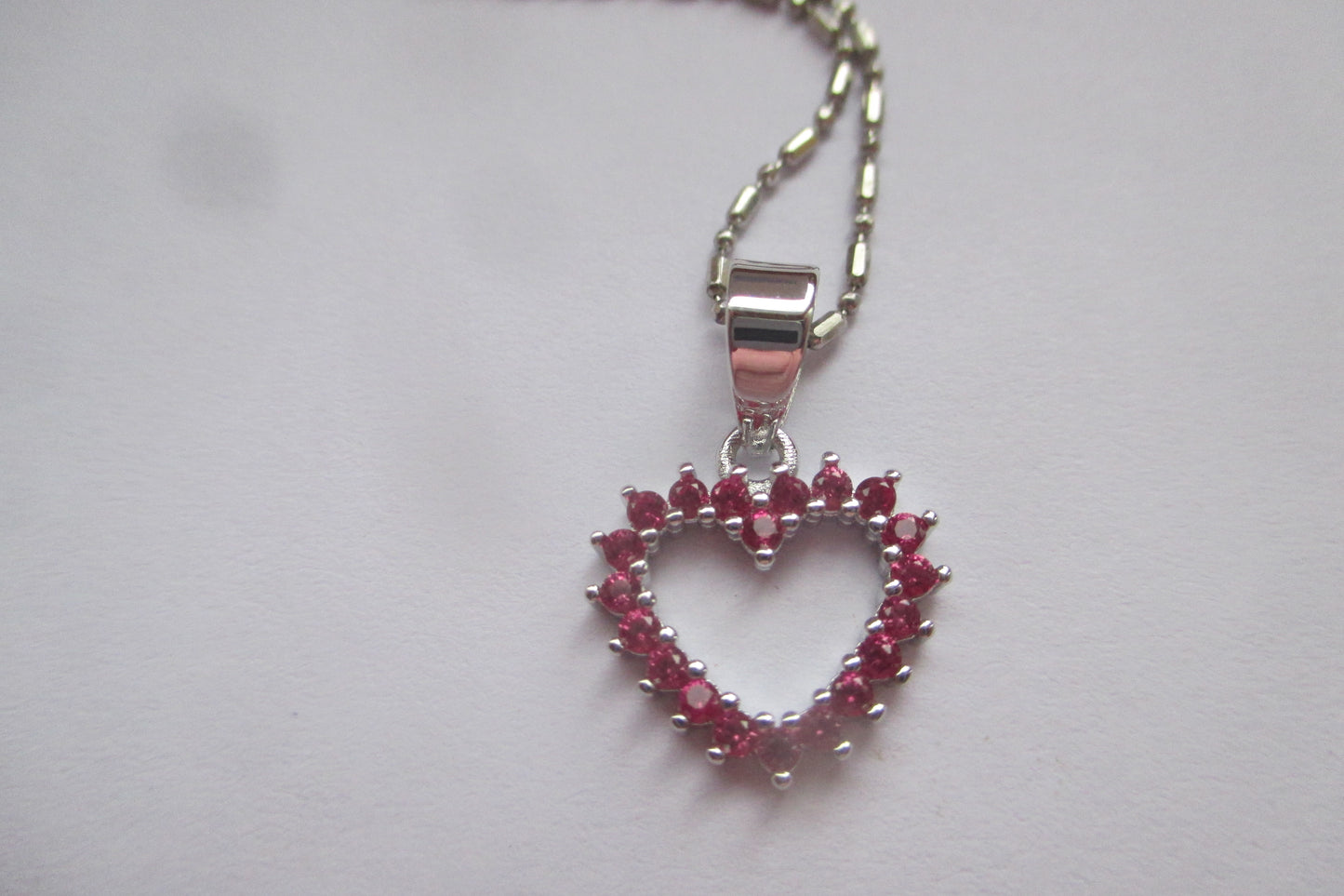 Silver hearts with red accents pendant