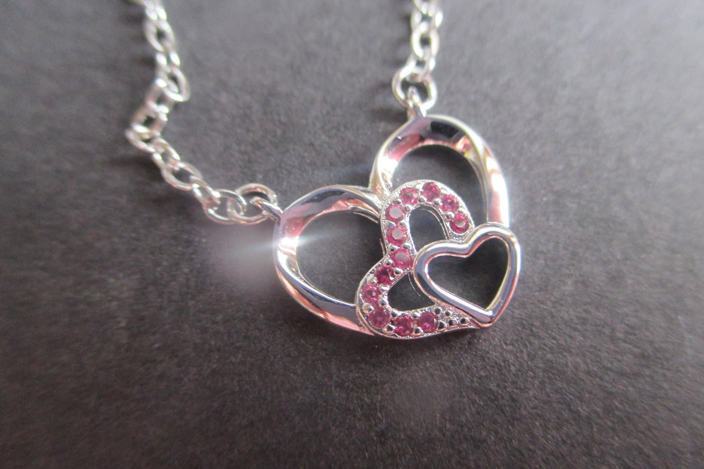 Silver hearts with red accents pendant