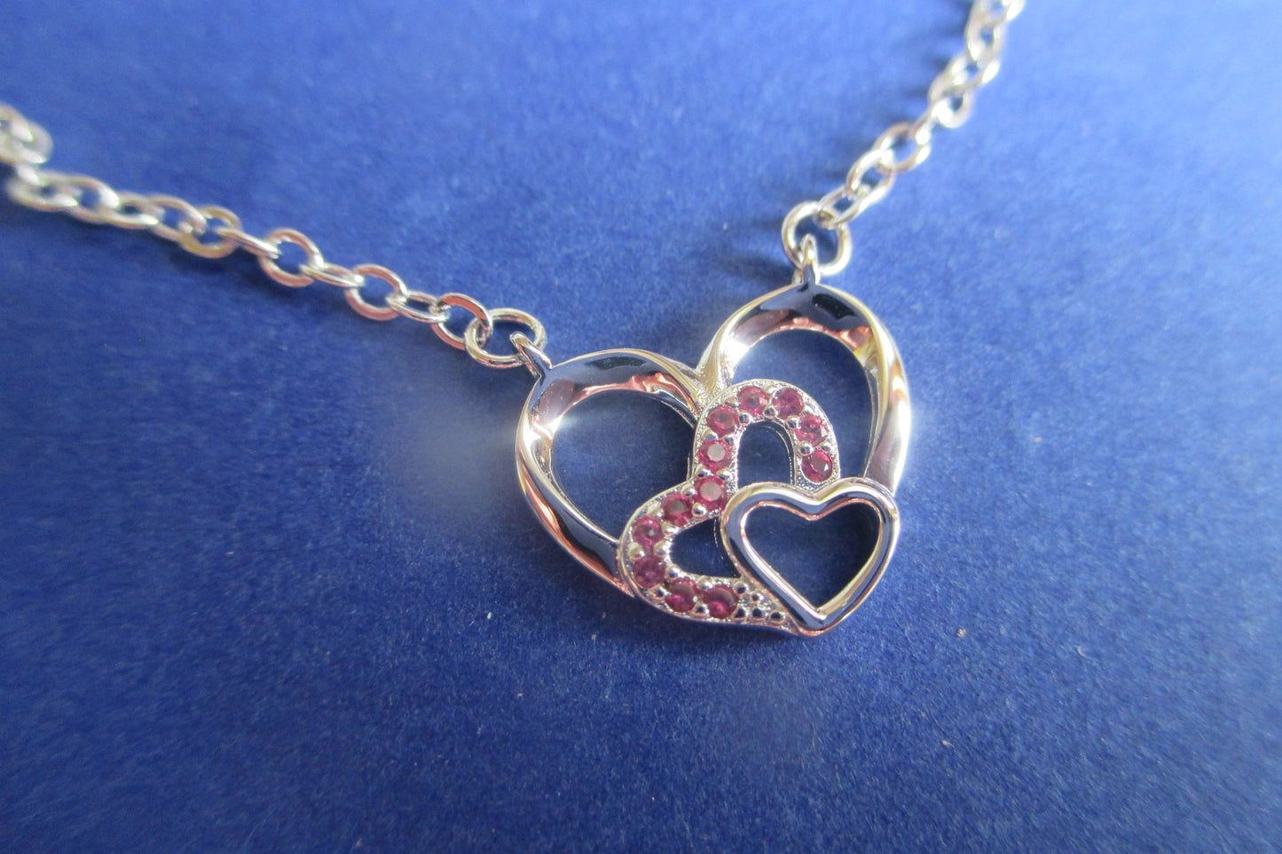 Silver hearts with red accents pendant