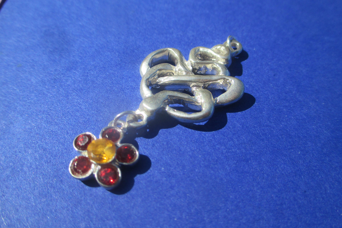 Silver snake pendant with flower drop