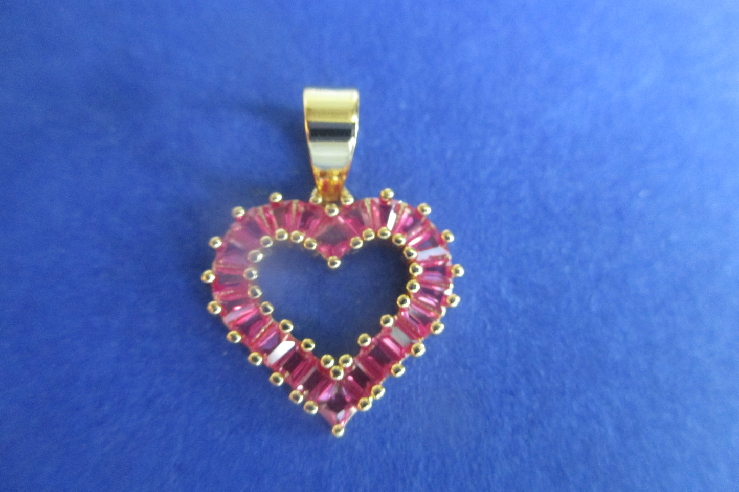 Gold plated HEART pendant with red stones.