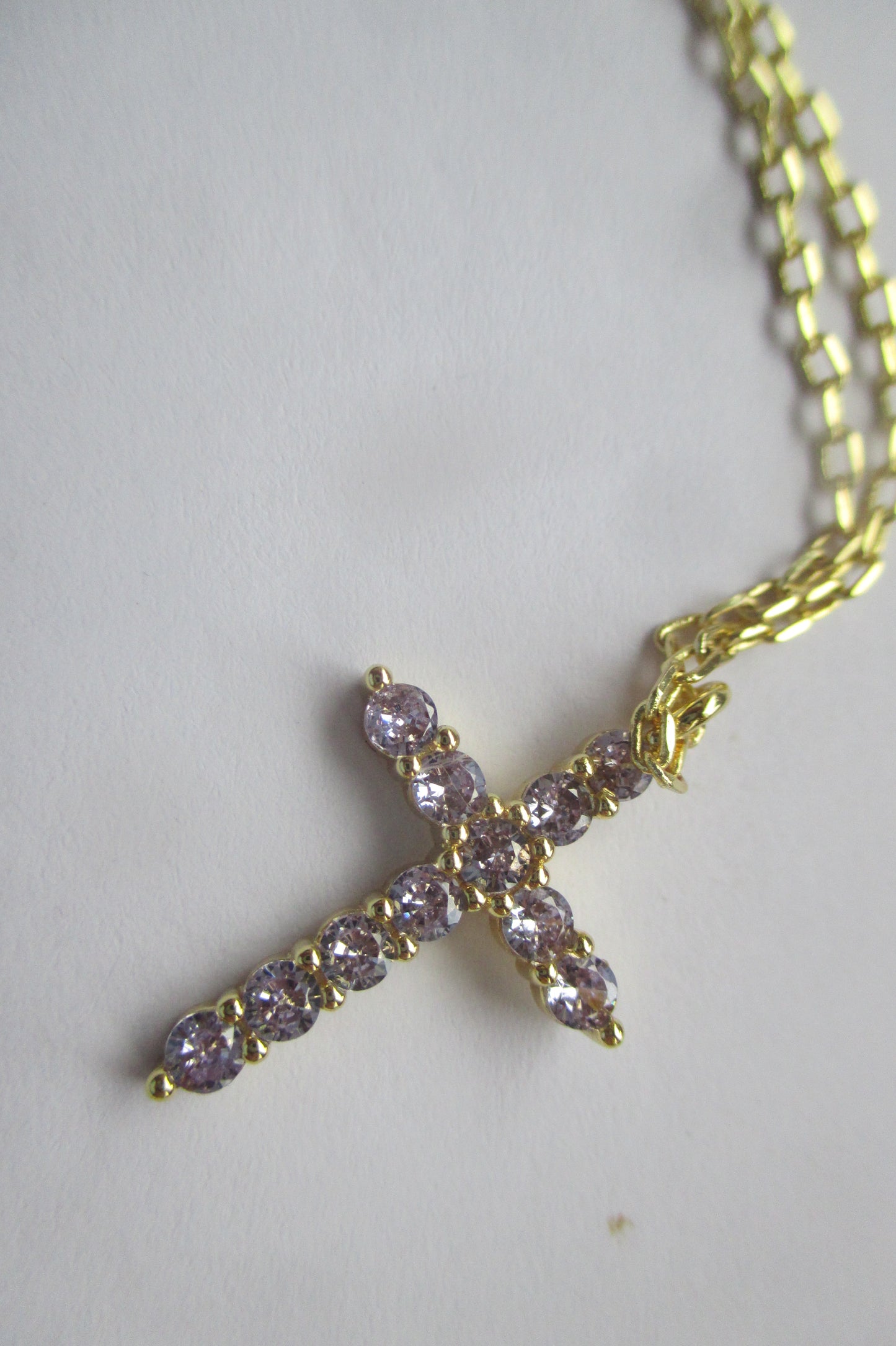 Gold plated violet stone cross pendant