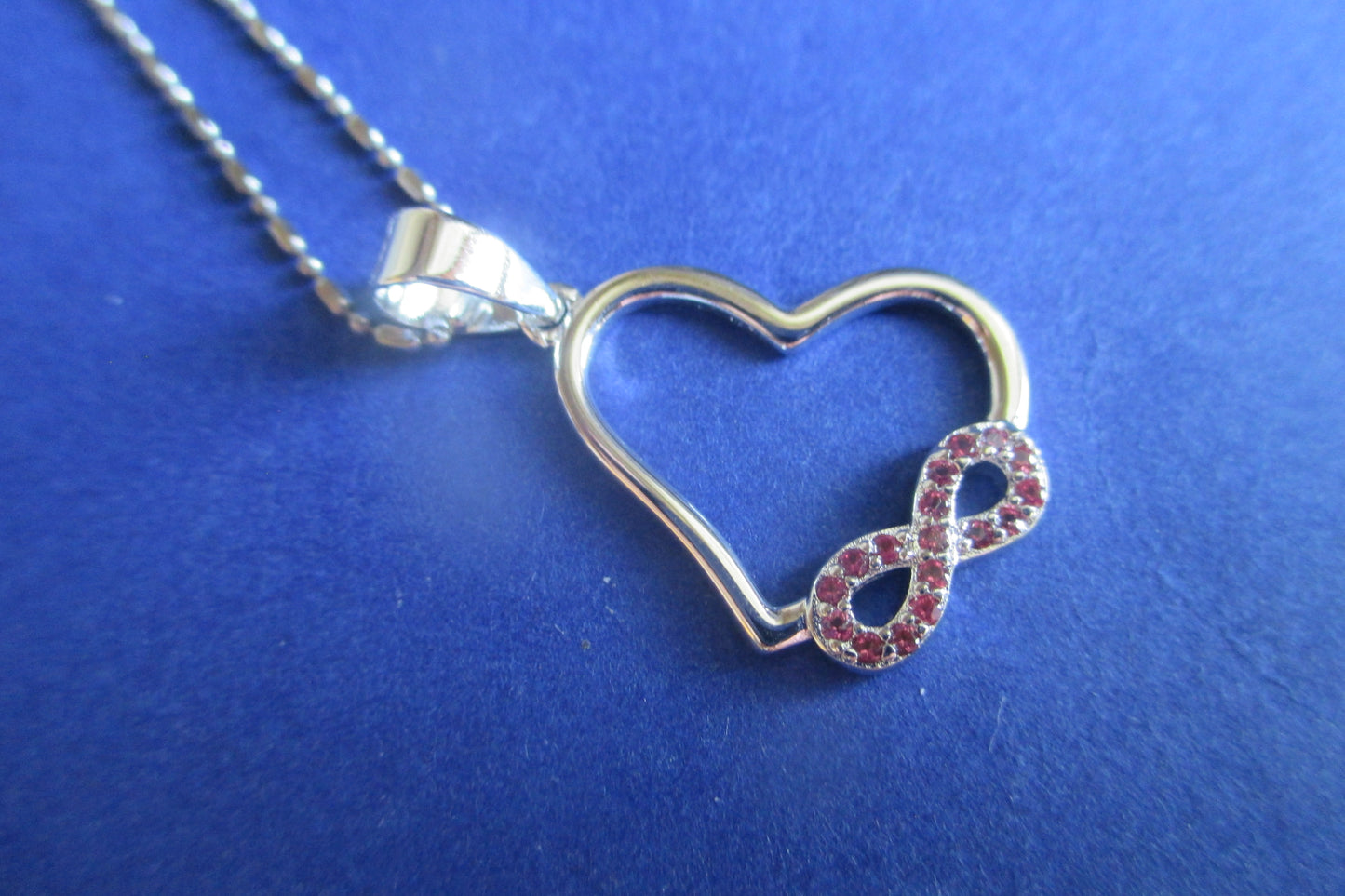 Silver heart with red accents pendant