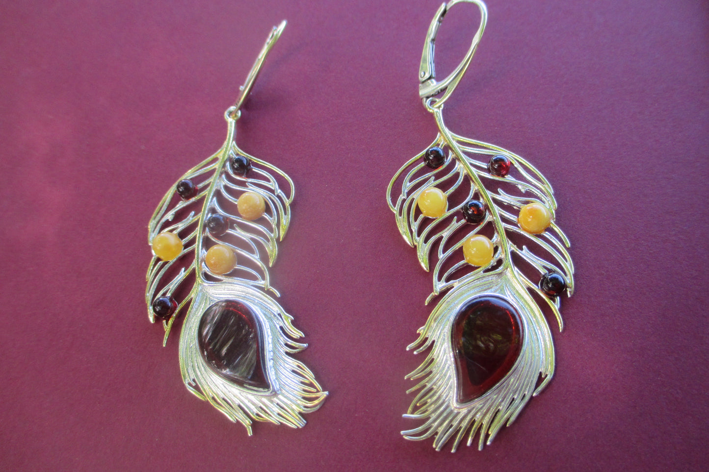 Amber peacock feather earrings