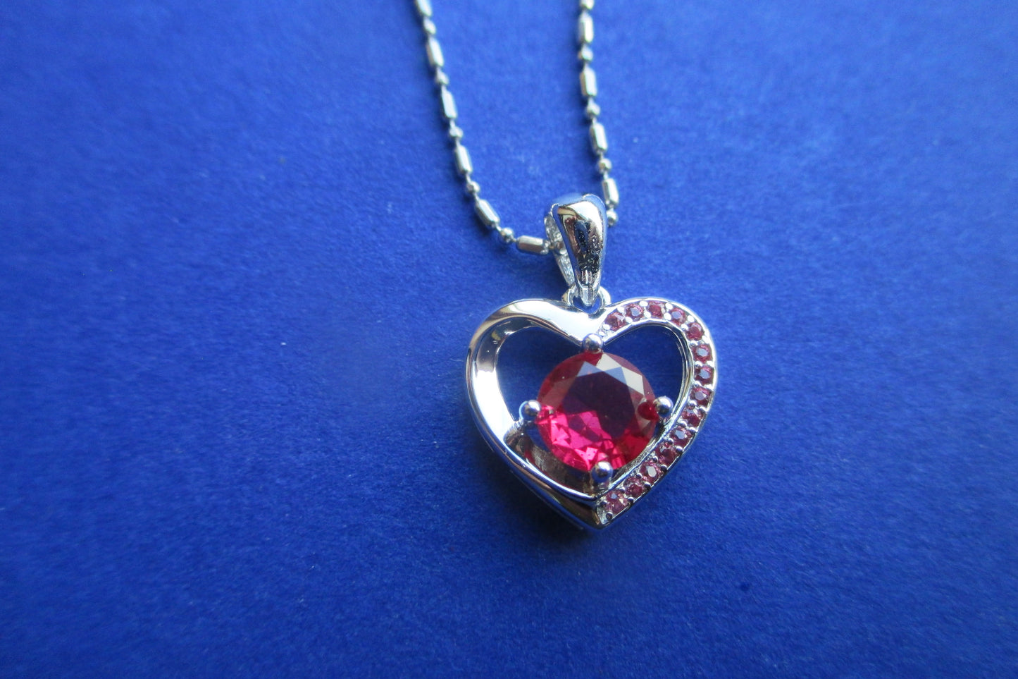 Silver heart with garnet pendant